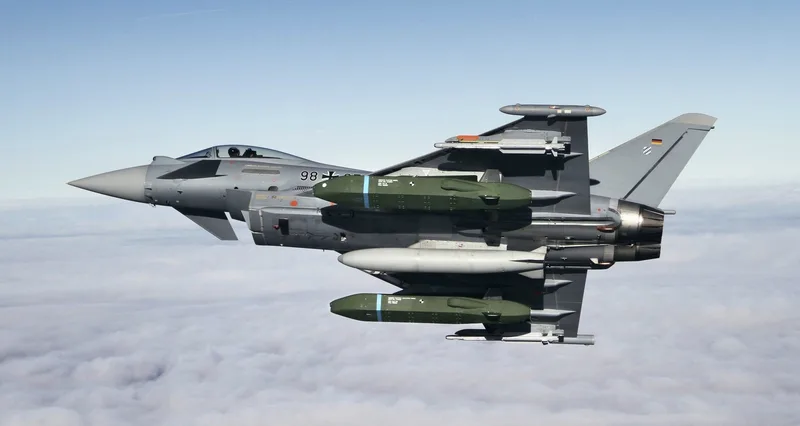Eurofighter der Luftwaffe mit zwei unter den Tragflächen montierten Taurus-Marschflugkörpern im Flug über einer Wolkendecke