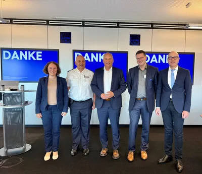 Krisenmanagement: Hessens Innenminister Roman Poseck und Vertreter des Katastrophenschutzes vor Präsentationsbildschirmen bei einer Fachveranstaltung