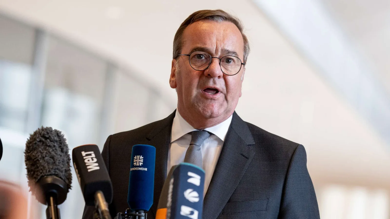 Bundesverteidigungsminister Boris Pistorius spricht vor Mikrofonen von ntv, WELT und der Bundeswehr bei einer Pressekonferenz