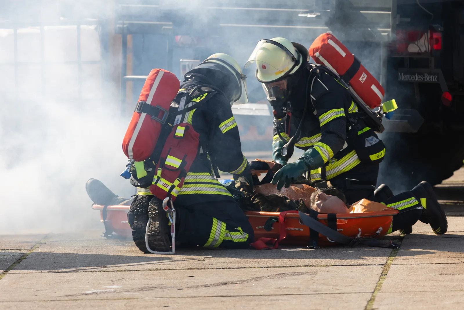 Einsatzkräfte helfen einem verletzten Betroffenen bei der Chemieunfallübung RedStorm Charlie in Hamburg.