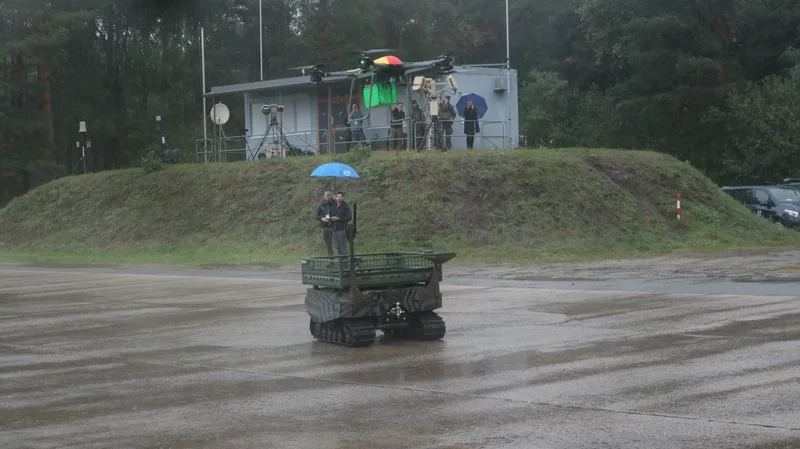A quadcopter prepares to hand over its package to a Gereon UGV.