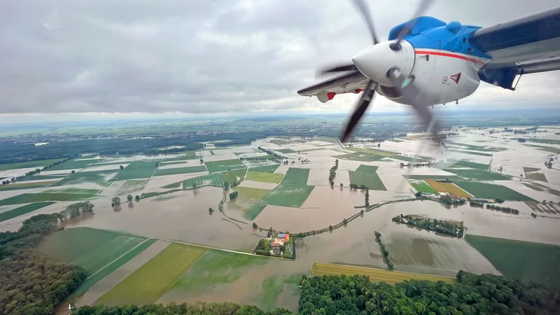 Bayern: Luftaufnahme aus einem Turboprop-Flugzeug über einem weiträumig überfluteten Gebiet mit eingeschlossenen Gebäuden und Infrastruktur