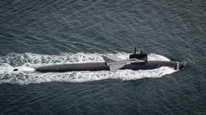 A Dassault Rafale M combat aircraft of the French Navy performs a low-level flyover of a surfaced Triomphant-class nuclear-powered ballistic missile submarine. France’s nuclear deterrent, comprising sea- and air-launched missiles, is undergoing modernisation and integration of new technologies such as hypersonics.