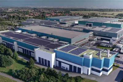 GlobalFoundries: Luftaufnahme eines Industriekomplexes mit großflächigen Photovoltaikanlagen auf den Flachdächern der Fabrikhallen