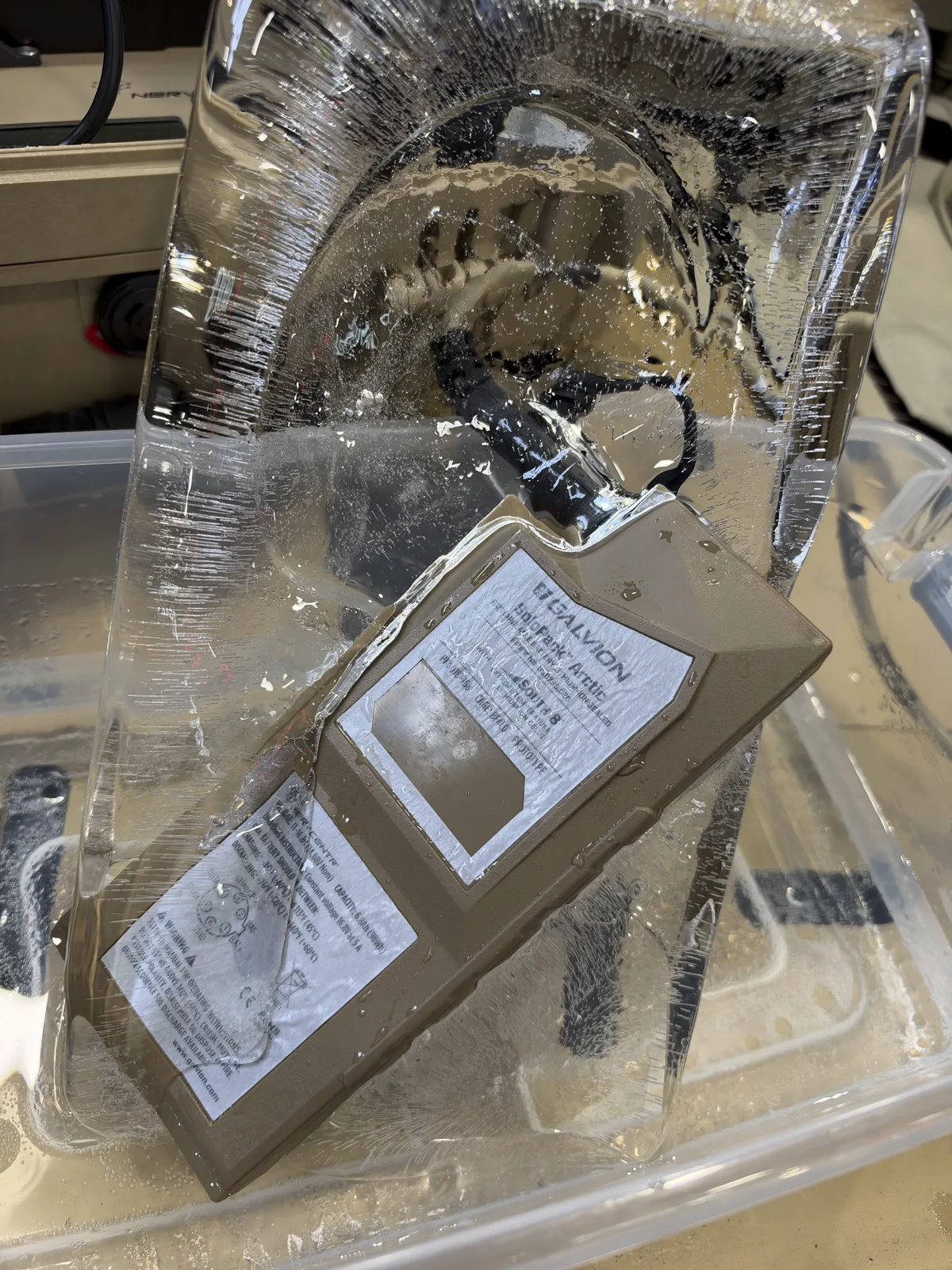 Galvion’s SoloPack Arctic rugged, extreme-cold-weather rechargeable battery, featuring LiGas technology from South 8, presented in a slab of ice at AUSA 2026.