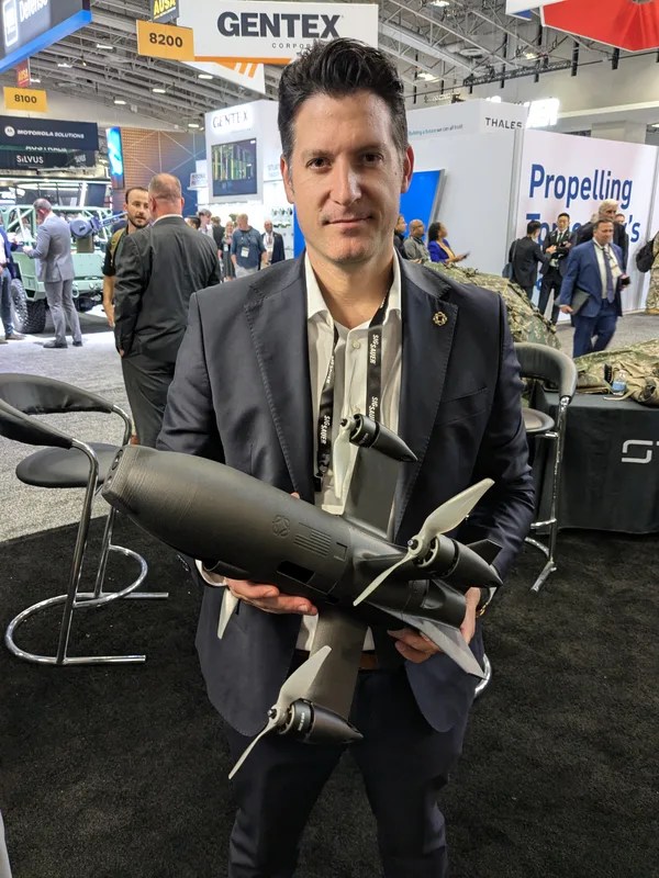 Brett Velicovich, president of Powerus, holding an example of the company’s Guardian-3 drone interceptor, which was launched at AUSA 2026.