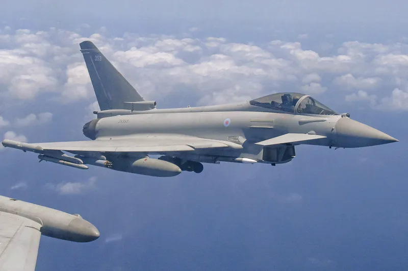 An RAF Typhoon FGR4 of No IX Squadron flying on what is believed to have been the type’s first operational APKWS sortie, with a single rocket pod under the starboard wing.